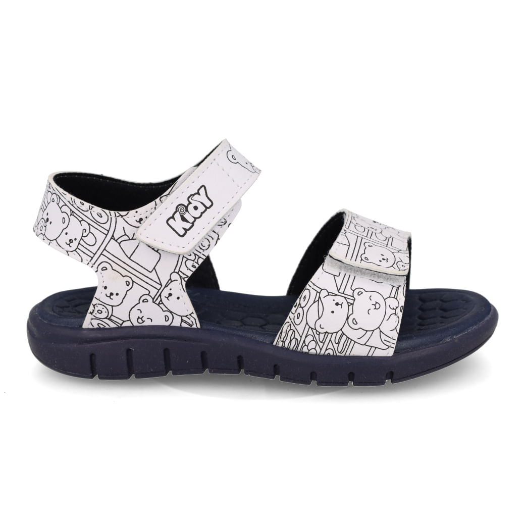 Vista lateral da sandália papete infantil Kidy branca com azul marinho, mostrando fechamento em velcro e solado antiderrapante